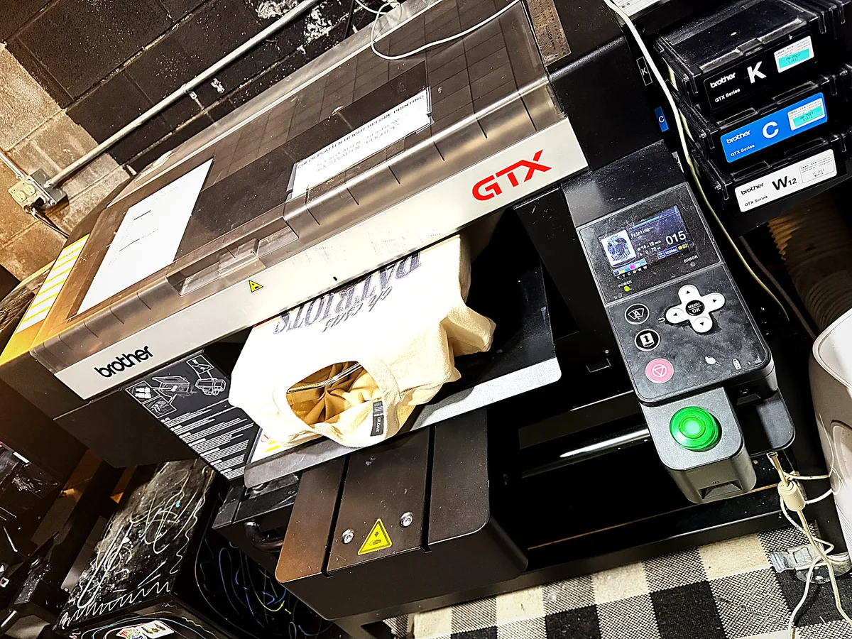 Brother GTX direct-to-garment printer laying ink on a tee