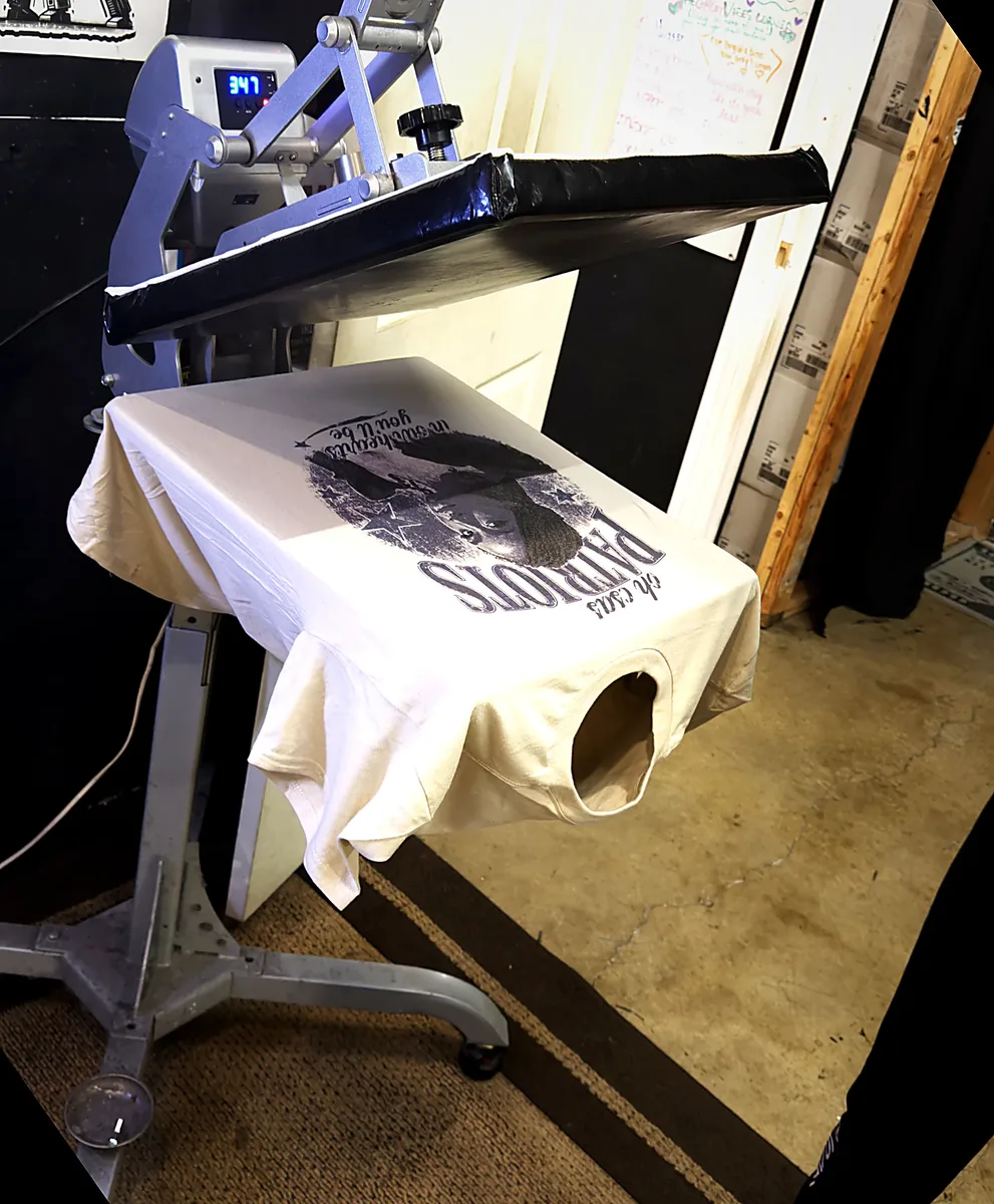A finished tee on the heat press stand
