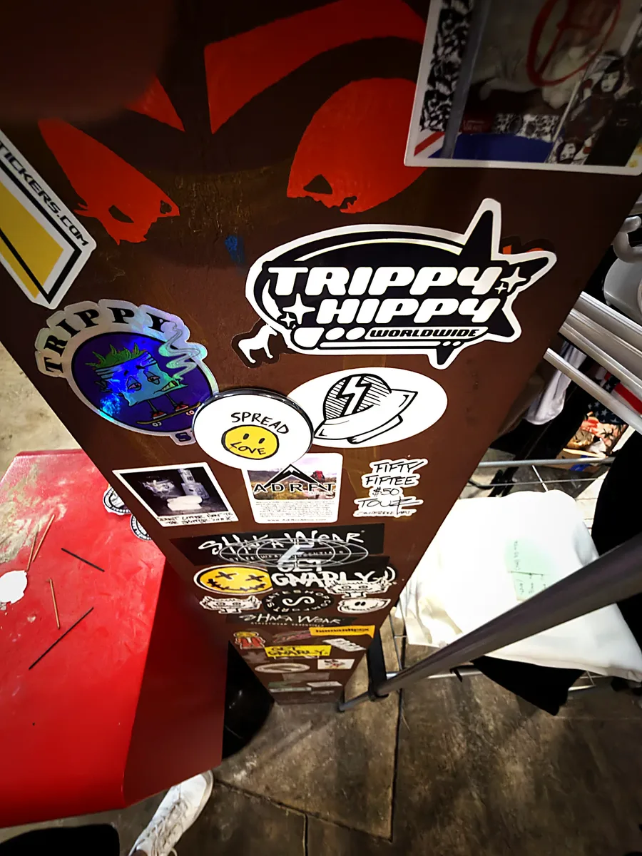Sticker-bombed pillar in the middle of the shop